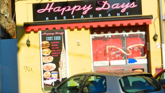 Fonzi would eat here. The donut on the sign is a bagel. The ice cream brand is "M & M."